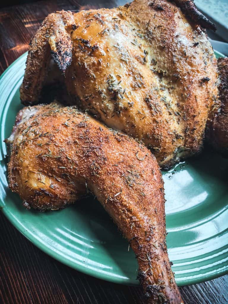 smoked dry brine chicken on a traeger with thyme and mustard spatchcocked